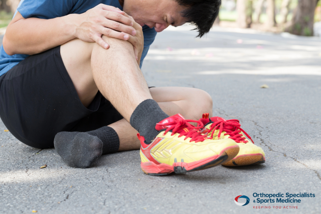 A man in pain from dislocating his knee while running in Granville, Ohio.