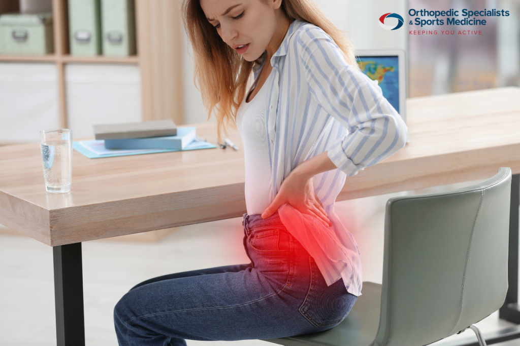 Woman suffering from hip impingement is in pain while sitting in Coshocton, Ohio.