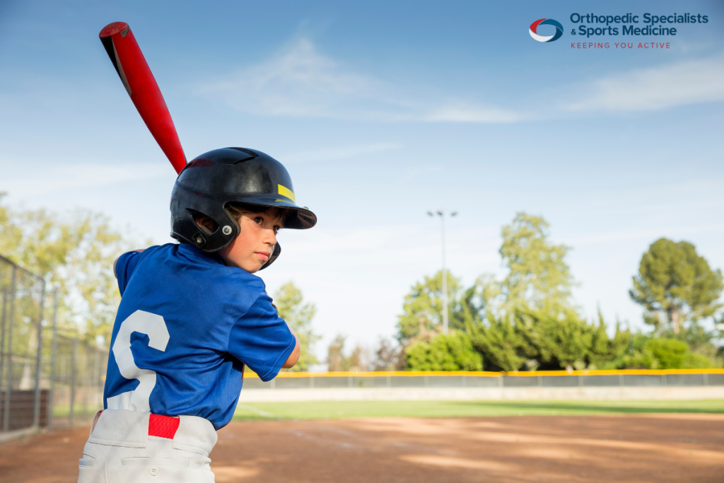 A child wearing protective gear to prevent injury while playing baseball in Ohio.