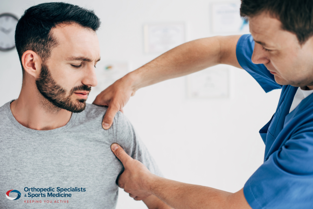 A doctor examining a patient with shoulder pain before surgery in Ohio.
